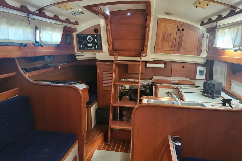 Slide: The Image of Interior of 1984 Sea Sprite 34 sailboat with wooden cabinetry and cozy seating. - 3