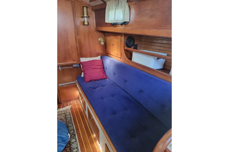 Slide: The Image of Interior of 1984 Sea Sprite 34 sailboat with blue cushioned seating and wooden paneling. - 4