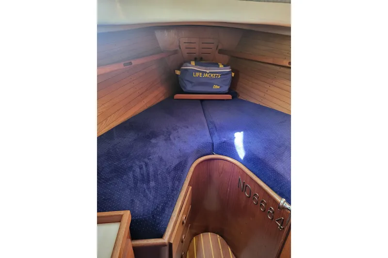 Slide: The Image of 1984 Sea Sprite 34 interior cabin with blue cushions and life jackets. - 6