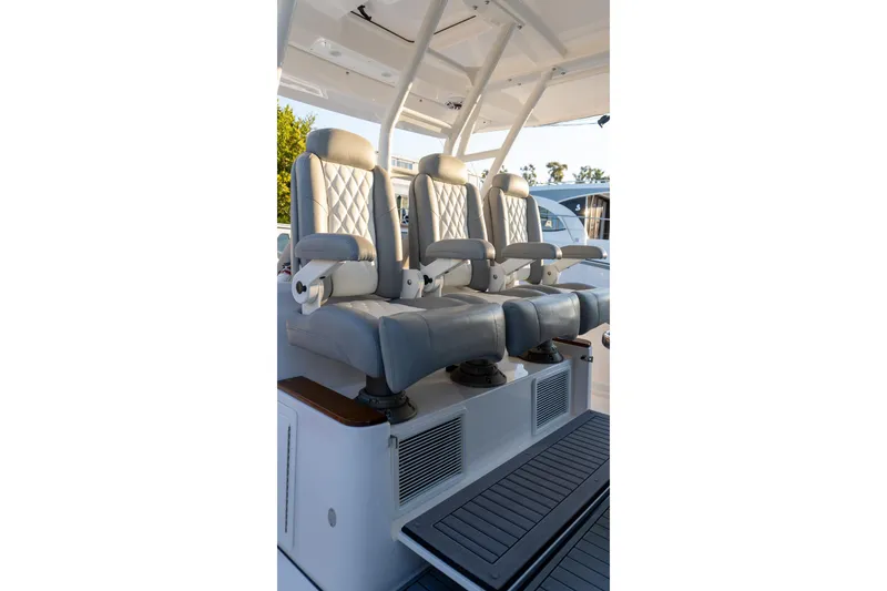 Slide: The Image of Luxury seating on 2024 Everglades 395 Center Console boat, featuring plush, adjustable captain chairs. - 16