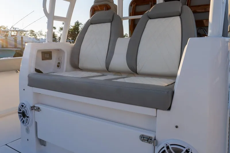Slide: The Image of 2024 Everglades 395 Center Console boat seating with gray and white upholstery. - 18