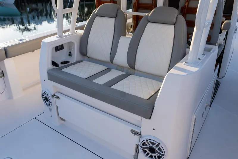 Slide: The Image of 2024 Everglades 395 Center Console boat seating with elegant upholstery and built-in speakers. - 19