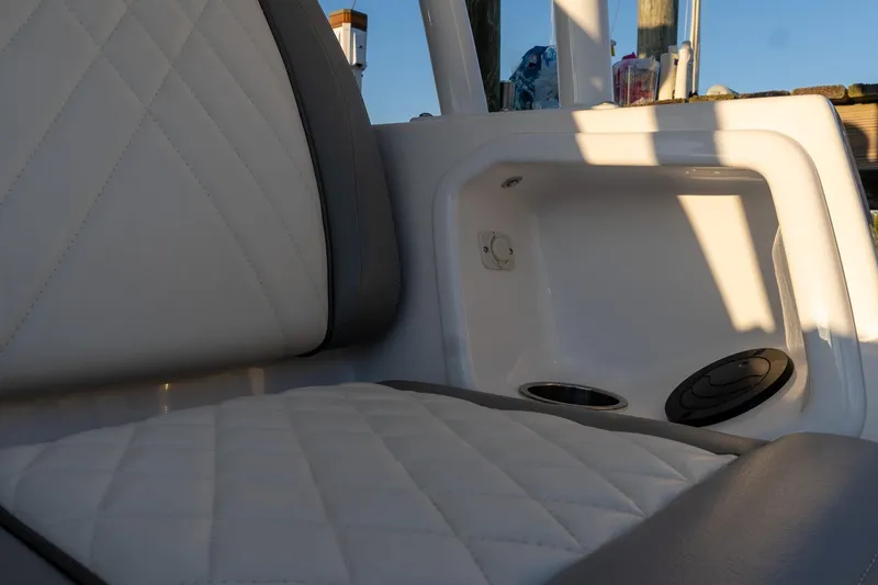 Slide: The Image of 2024 Everglades 395 Center Console interior with quilted seating and storage compartment. - 21