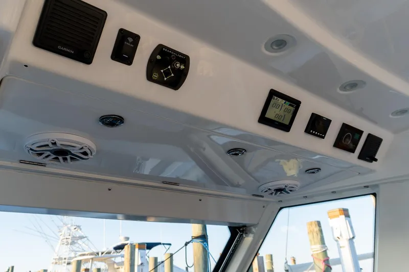 Slide: The Image of 2024 Everglades 395 Center Console dashboard with electronic controls and speakers. - 22