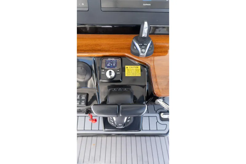 Slide: The Image of 2024 Everglades 395 Center Console helm controls with modern navigation equipment. - 30