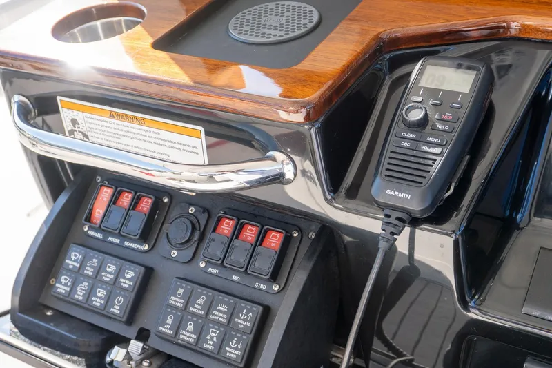 Slide: The Image of Control panel of 2024 Everglades 395 Center Console with Garmin radio and switches. - 31