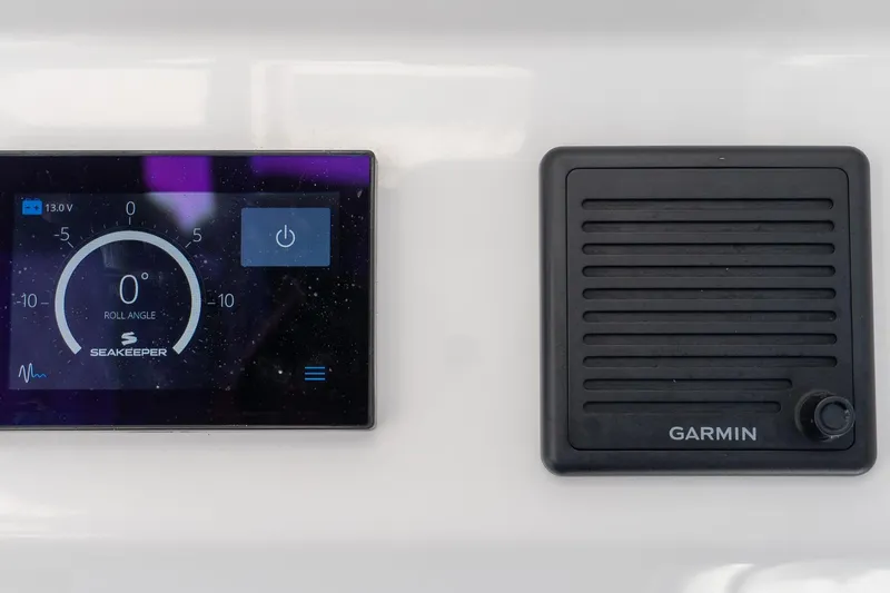 Slide: The Image of 2024 Everglades 395 Center Console dashboard with Seakeeper and Garmin displays. - 33