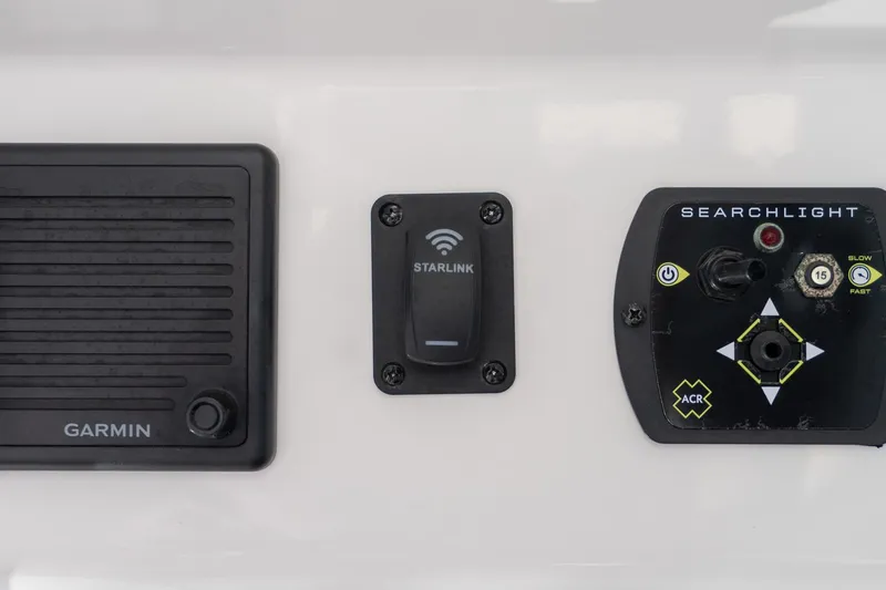 Slide: The Image of Control panel of 2024 Everglades 395 Center Console with Garmin, Starlink, and searchlight controls. - 34