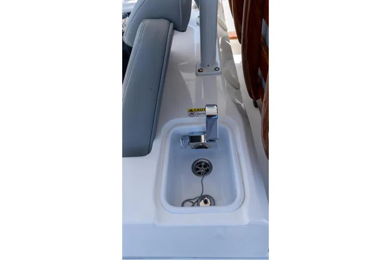 Slide: The Image of 2024 Everglades 395 Center Console boat sink with chrome faucet and drain plug. - 35