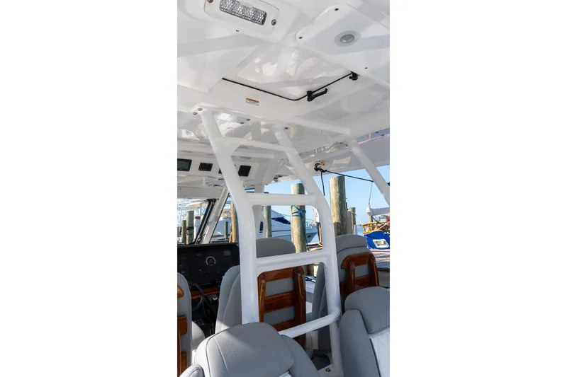Slide: The Image of 2024 Everglades 395 Center Console interior with seating and helm station. - 37