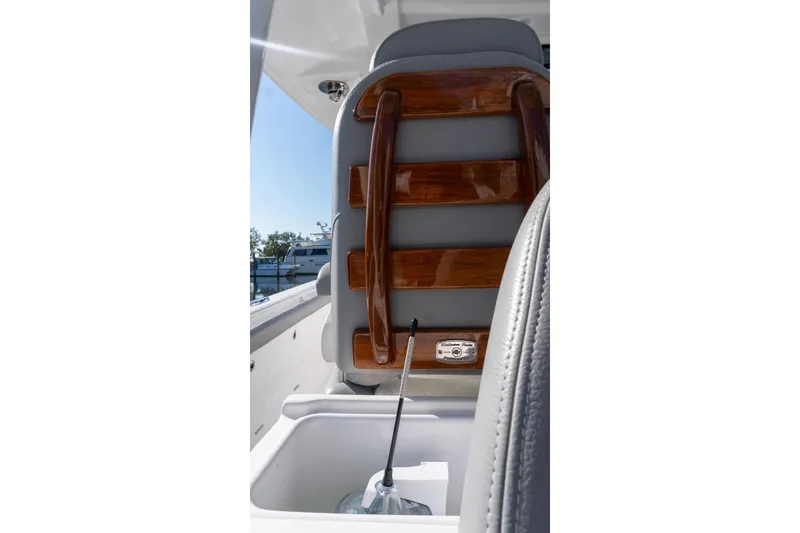 Slide: The Image of 2024 Everglades 395 Center Console interior with wooden accents and storage compartment. - 38