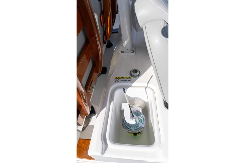 Slide: The Image of 2024 Everglades 395 Center Console boat interior with cup holder and caution label. - 39