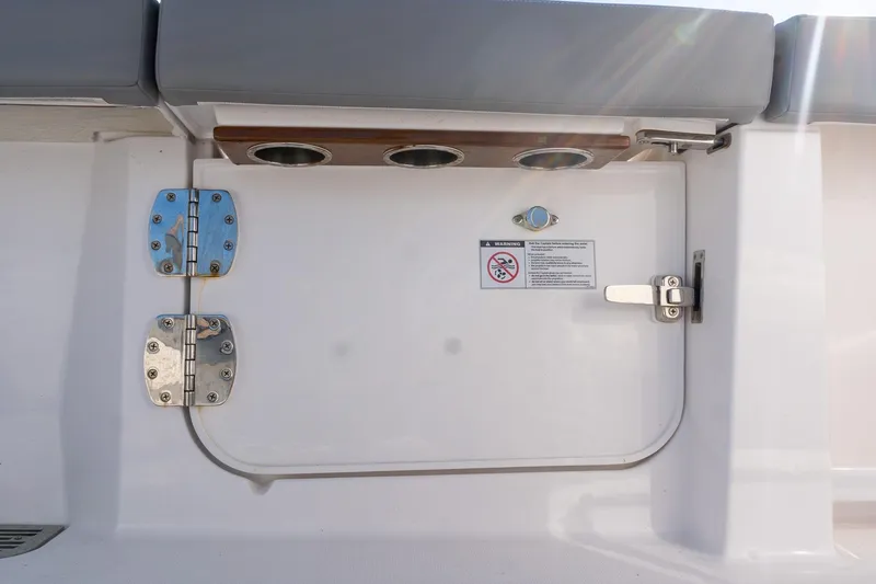 Slide: The Image of 2024 Everglades 395 Center Console boat hatch with stainless steel hinges and warning label. - 42
