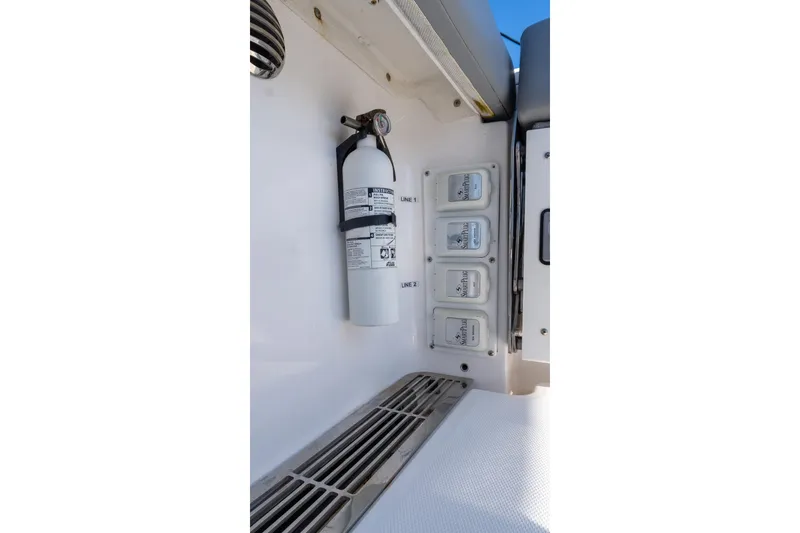 Slide: The Image of 2024 Everglades 395 Center Console interior with fire extinguisher and control panel. - 45