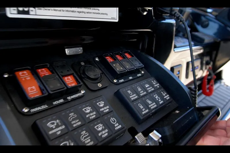 Slide: The Image of Control panel of 2024 Everglades 395 Center Console boat with switches and buttons. - 46