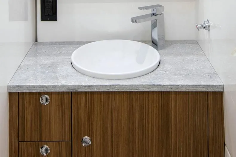 Slide: The Image of Manufacturer Provided Image: Modern sink and faucet on wood cabinet in 2024 Everglades 395 Center Console boat. - 53
