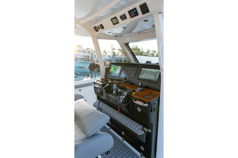 Slide: The Image of 2024 Everglades 395 Center Console boat cockpit with advanced navigation displays. - 7