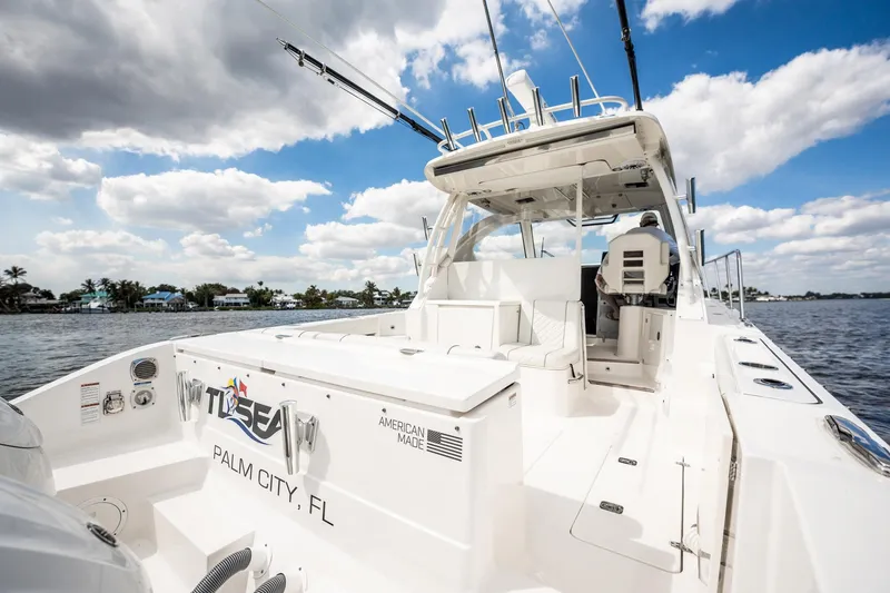 Slide: The Image of 2024 Pursuit OS 325 Offshore boat on water, Palm City, FL, under cloudy sky. - 12