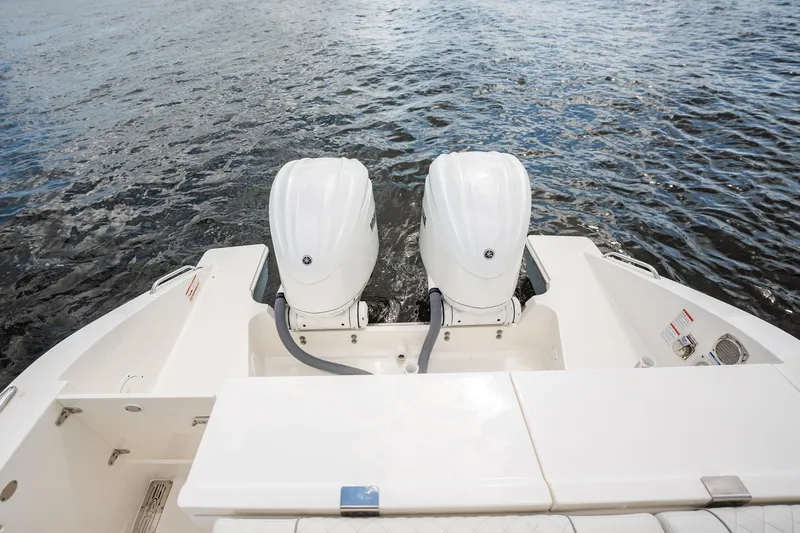 Slide: The Image of 2024 Pursuit OS 325 Offshore boat with dual outboard engines on water. - 19