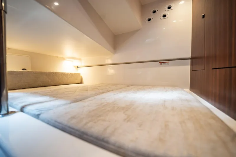 Slide: The Image of 2024 Pursuit OS 325 Offshore cabin interior with cozy bed and modern design. - 30