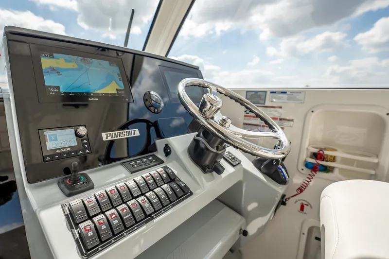 Slide: The Image of 2024 Pursuit OS 325 Offshore helm with advanced navigation and control systems. - 6