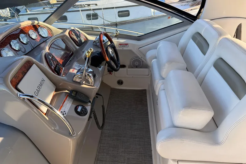 Slide: The Image of 2006 Sea Ray Sundancer 320 helm with Garmin navigation and plush seating. - 10
