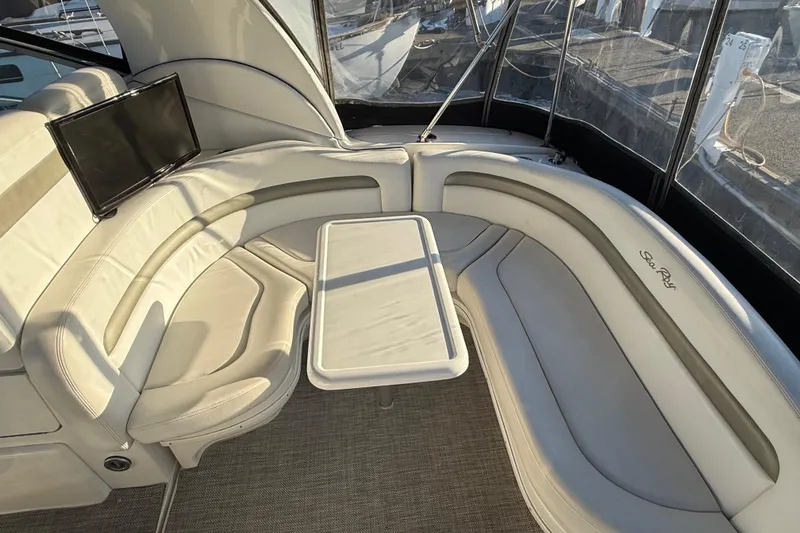 Slide: The Image of Luxurious interior of 2006 Sea Ray Sundancer 320 with curved seating and table. - 18