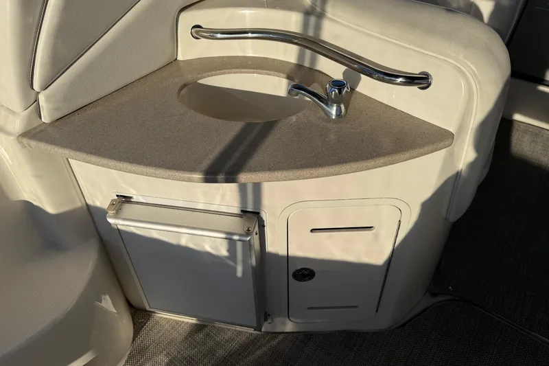 Slide: The Image of 2006 Sea Ray Sundancer 320 boat interior with sink and storage area. - 21
