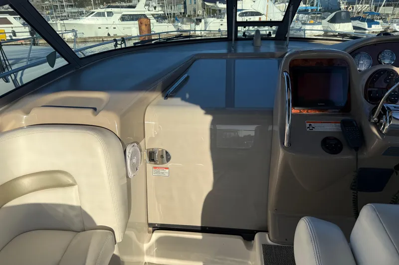 Slide: The Image of 2006 Sea Ray Sundancer 320 helm with navigation equipment and comfortable seating. - 23