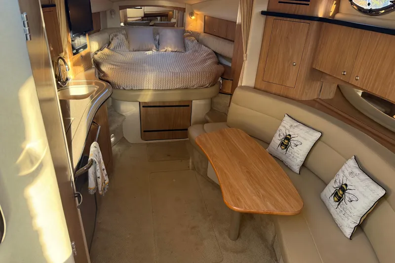 Slide: The Image of 2006 Sea Ray Sundancer 320 interior with cozy bed, kitchenette, and seating area. - 25