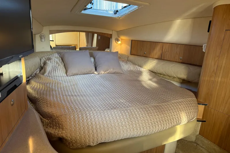 Slide: The Image of Luxurious cabin interior of 2006 Sea Ray Sundancer 320 yacht with cozy bedding. - 27