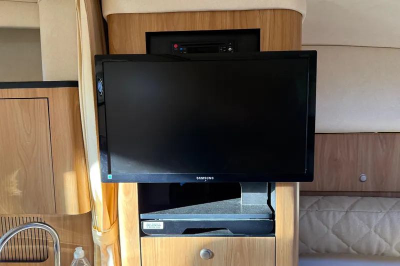 Slide: The Image of Samsung TV in 2006 Sea Ray Sundancer 320 cabin with wood paneling. - 29