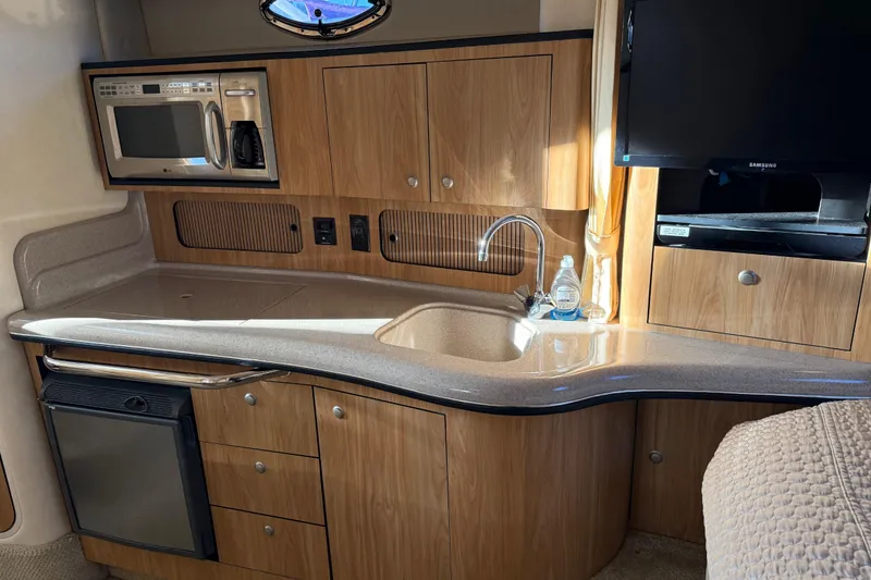 Slide: The Image of Interior of 2006 Sea Ray Sundancer 320 yacht with kitchenette and modern amenities. - 30