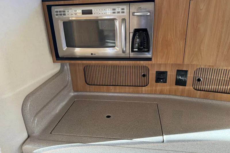 Slide: The Image of 2006 Sea Ray Sundancer 320 galley with microwave and coffee maker. - 31
