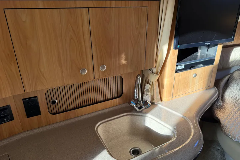Slide: The Image of Interior of 2006 Sea Ray Sundancer 320 with sink, cabinets, and TV. - 34