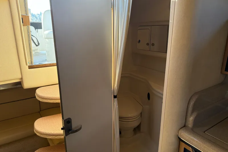 Slide: The Image of 2006 Sea Ray Sundancer 320 interior with bathroom, steps, and seating area. - 39