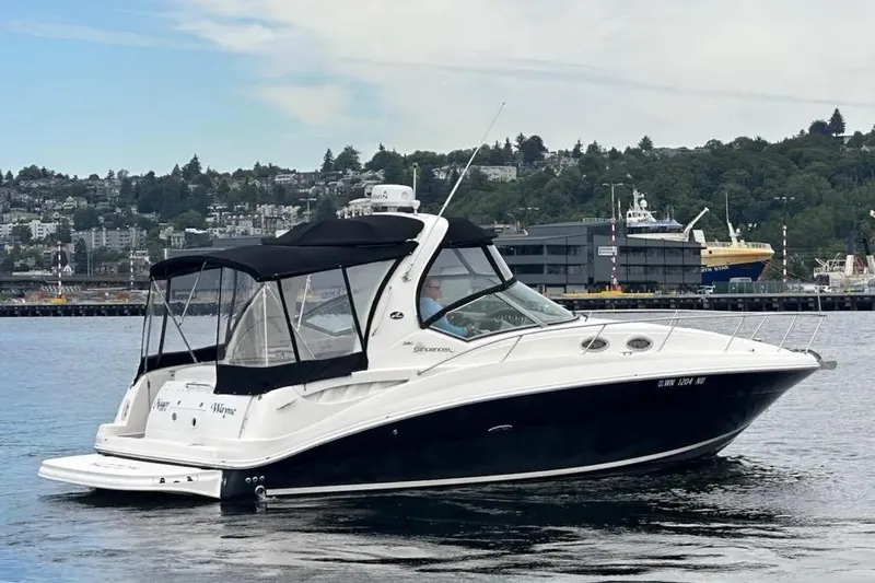 Slide: The Image of 2006 Sea Ray Sundancer 320 boat on water, with cityscape background. - 5
