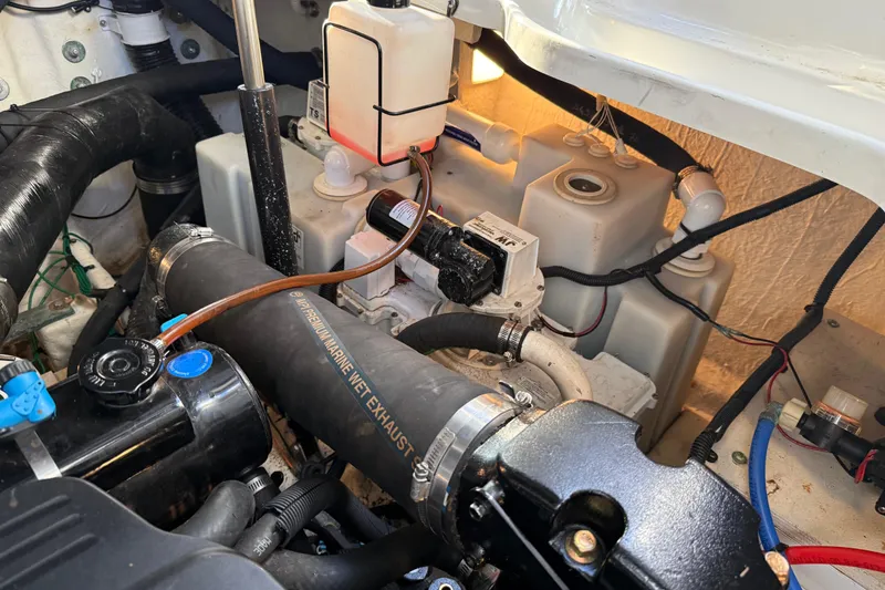 Slide: The Image of Engine compartment of a 2006 Sea Ray Sundancer 320, showcasing marine components and wiring. - 50