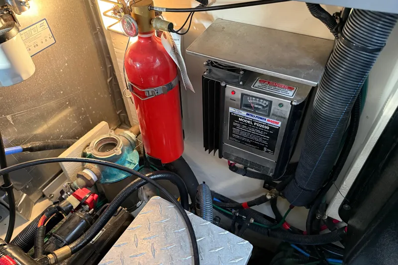 Slide: The Image of Engine room of 2006 Sea Ray Sundancer 320 with fire extinguisher and power converter. - 51