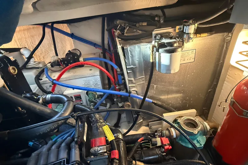 Slide: The Image of Engine compartment of a 2006 Sea Ray Sundancer 320 with visible wiring and components. - 52