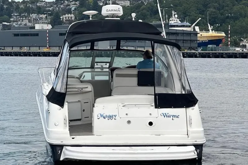 Slide: The Image of 2006 Sea Ray Sundancer 320 boat on water, rear view with harbor background. - 6