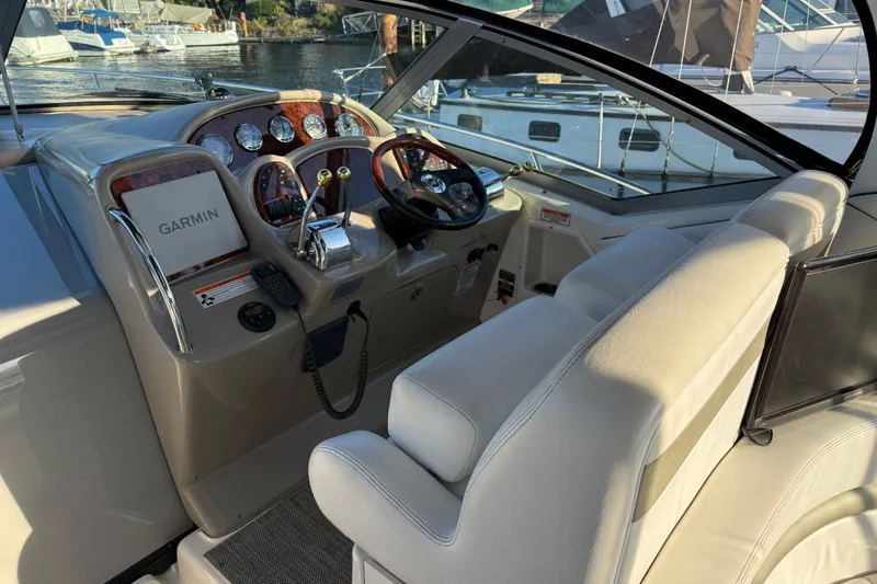 Slide: The Image of 2006 Sea Ray Sundancer 320 cockpit with Garmin navigation, luxurious seating, and control panel. - 8