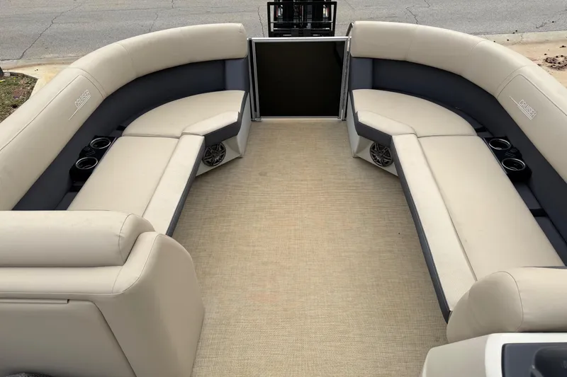 Slide: The Image of 2025 Harris Cruiser 230 interior with beige seating and cup holders. - 4