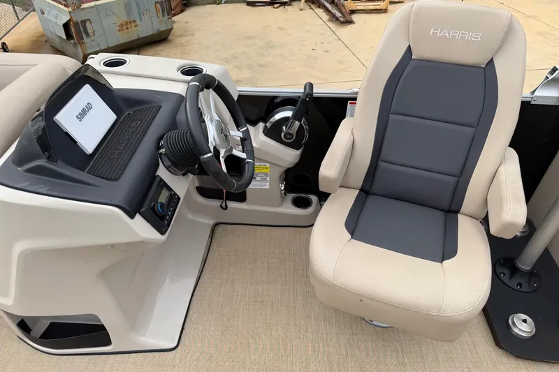 Slide: The Image of 2025 Harris Cruiser 230 boat interior with steering wheel and captain's chair. - 6