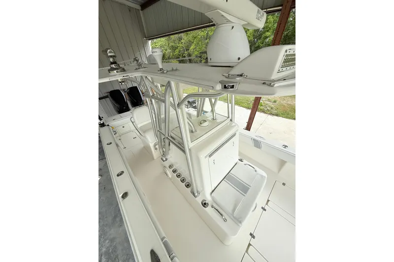 Slide: The Image of 2019 SeaVee 320B boat interior with seating and storage, under a covered structure. - 14