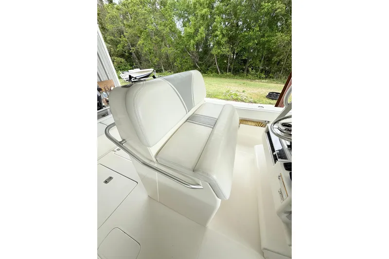 Slide: The Image of 2019 SeaVee 320B boat interior with white cushioned seating and steering wheel. - 16