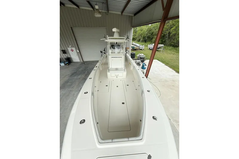 Slide: The Image of 2019 SeaVee 320B boat in a covered storage area, showcasing spacious deck layout. - 17