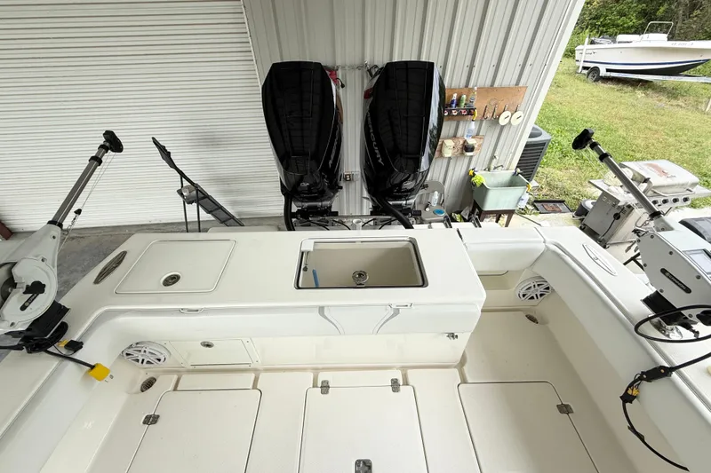 Slide: The Image of 2019 SeaVee 320B boat with dual outboard motors in a covered storage area. - 18