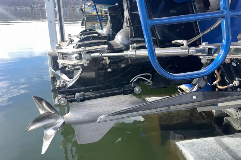 Slide: The Image of 1998 Cigarette 38' Top Gun boat propeller and engine detail by the water. - 11