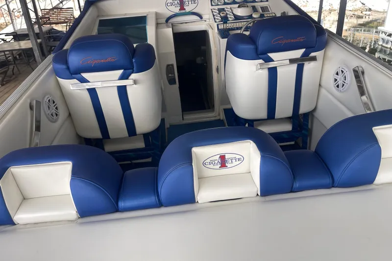 Slide: The Image of Interior of a 1998 Cigarette 38' Top Gun boat with blue and white seating. - 17